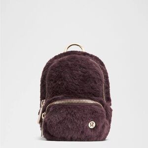 lululemon athletica Mini Faux Fur Backpack in Deep Plum with Gold Hardware